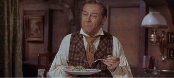 Movie still from “Doctor Dolittle” (1967), directed by Richard Fleischer – A man in a vest and tie eating food; Close Up shot, High angle
