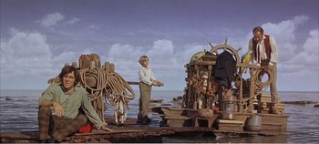 Movie still from “Doctor Dolittle” (1967), directed by Richard Fleischer – A man standing on a pier holding a fishing pole; Wide shot, Low angle