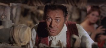 Movie still from “Doctor Dolittle” (1967), directed by Richard Fleischer – A person wearing a shirt and tie; Close Up shot, Over the shoulder angle