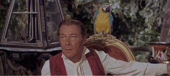 Movie still from “Doctor Dolittle” (1967), directed by Richard Fleischer – A person sitting with a bird; Close Up shot, Low angle