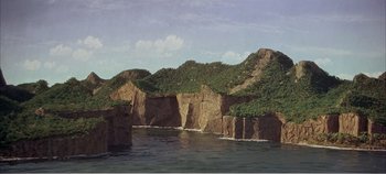 Movie still from “Doctor Dolittle” (1967), directed by Richard Fleischer – A view of a body of water with a mountain in the background; Extreme Wide shot, High angle