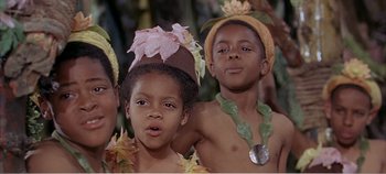 Movie still from “Doctor Dolittle” (1967), directed by Richard Fleischer – Two boys and a girl in native costumes; Close Up shot, Low angle