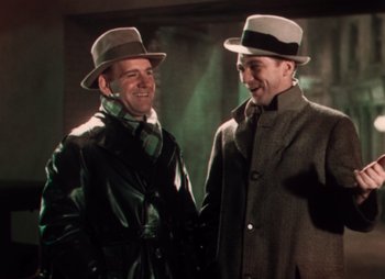 Movie still from “Doctor X” (1932), directed by Michael Curtiz – A couple of men standing next to each other; Medium shot, Low angle