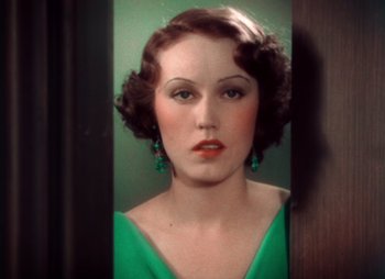 Movie still from “Doctor X” (1932), directed by Michael Curtiz – A woman in a green dress looking into a mirror; Close Up shot, High angle