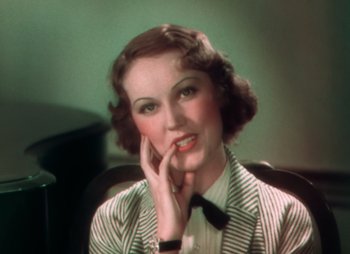 Movie still from “Doctor X” (1932), directed by Michael Curtiz – An old photo of a woman with a black and white striped shirt; Close Up shot, High angle