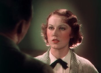 Movie still from “Doctor X” (1932), directed by Michael Curtiz – A woman in a striped jacket looking at a man in a suit; Close Up shot, Over the shoulder angle