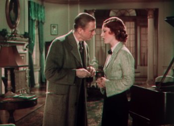 Movie still from “Doctor X” (1932), directed by Michael Curtiz – An older man and a young woman in a room with a piano; Medium shot, High angle