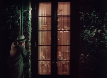 Movie still from “Doctor X” (1932), directed by Michael Curtiz – A man standing in front of a window at night; Wide shot, High angle