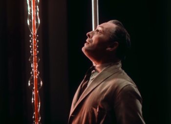Movie still from “Doctor X” (1932), directed by Michael Curtiz – A man standing in front of a pole with lights; Medium shot, Low angle