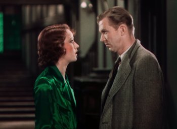 Movie still from “Doctor X” (1932), directed by Michael Curtiz – An older man and a younger woman standing next to each other; Medium shot, High angle