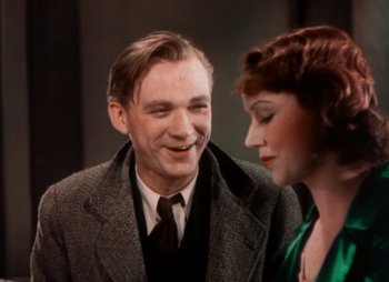 Movie still from “Doctor X” (1932), directed by Michael Curtiz – An older man and a younger woman are smiling for the camera; Close Up shot, High angle