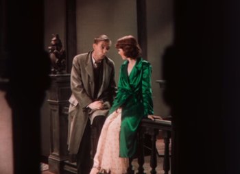 Movie still from “Doctor X” (1932), directed by Michael Curtiz – A man and a woman sitting next to each other on a bench; Medium shot, High angle