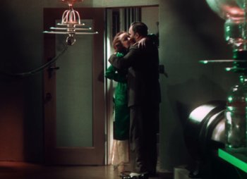 Movie still from “Doctor X” (1932), directed by Michael Curtiz – A man and a woman kissing in a room; Wide shot, Low angle