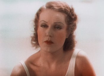 Movie still from “Doctor X” (1932), directed by Michael Curtiz – An old photo of a woman in a white dress; Close Up shot, High angle
