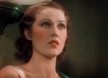 Movie still from “Doctor X” (1932), directed by Michael Curtiz – A woman with green eye shadow and green lipstick; Close Up shot, Low angle