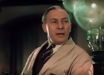 Movie still from “Doctor X” (1932), directed by Michael Curtiz – An older man wearing a suit and a tie; Close Up shot, Low angle