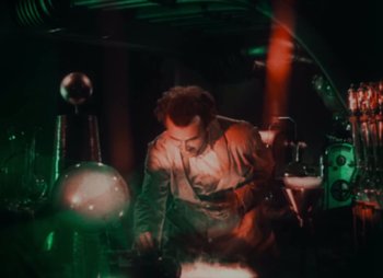 Movie still from “Doctor X” (1932), directed by Michael Curtiz – A man working in an industrial setting with green and red lighting; Medium shot, Low angle