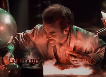 Movie still from “Doctor X” (1932), directed by Michael Curtiz – A man playing a game of chess in a dark room; Medium shot, High angle