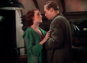 Movie still from “Doctor X” (1932), directed by Michael Curtiz – An older man and a younger woman are standing together; Medium shot, High angle