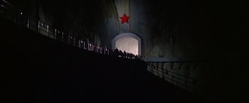 Movie still from “Doctor Zhivago” (1965), directed by David Lean – A group of people standing in a tunnel with a red star on it; Extreme Wide shot, Low angle