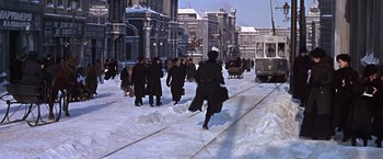 Movie still from “Doctor Zhivago” (1965), directed by David Lean – A group of people walking down a snow covered street; Extreme Wide shot, High angle