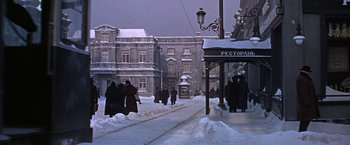 Movie still from “Doctor Zhivago” (1965), directed by David Lean – A group of people walking down a snow covered sidewalk; Extreme Wide shot, High angle