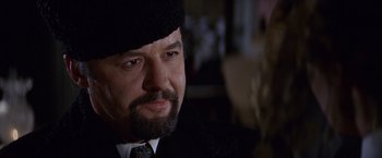 Movie still from “Doctor Zhivago” (1965), directed by David Lean – A person wearing a suit and a hat; Close Up shot, Over the shoulder angle