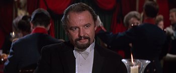 Movie still from “Doctor Zhivago” (1965), directed by David Lean – A person wearing a suit and a bow tie; Close Up shot, Low angle