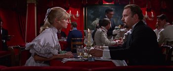 Movie still from “Doctor Zhivago” (1965), directed by David Lean – A woman sitting at a dinner table with a man; Medium shot, Over the shoulder angle