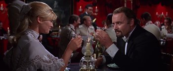 Movie still from “Doctor Zhivago” (1965), directed by David Lean – A man and a woman are toasting at a party; Medium shot, Over the shoulder angle