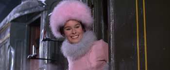 Movie still from “Doctor Zhivago” (1965), directed by David Lean – A woman wearing a pink coat and a fur hat; Close Up shot, Low angle