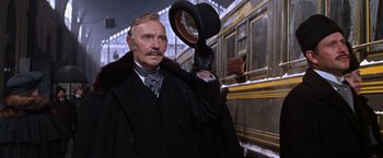 Movie still from “Doctor Zhivago” (1965), directed by David Lean – An old man in a black coat and a black hat; Medium shot, Low angle