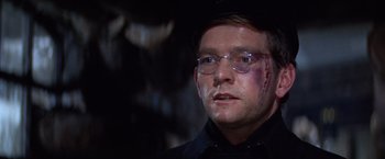 Movie still from “Doctor Zhivago” (1965), directed by David Lean – A person wearing glasses and a black shirt; Close Up shot, Over the shoulder angle