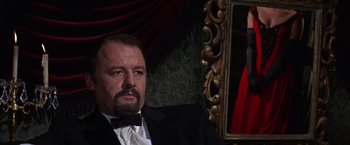 Movie still from “Doctor Zhivago” (1965), directed by David Lean – A man sitting in front of a mirror in front of a painting; Close Up shot, Low angle