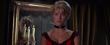 Movie still from “Doctor Zhivago” (1965), directed by David Lean – A woman in a red and black dress with a candle in the background; Close Up shot, Low angle