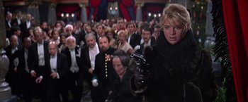 Movie still from “Doctor Zhivago” (1965), directed by David Lean – A woman holding a gun in front of a crowd of people; Medium shot, Low angle