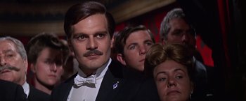 Movie still from “Doctor Zhivago” (1965), directed by David Lean – A man in a suit and tie with a bow tie; Close Up shot, Low angle
