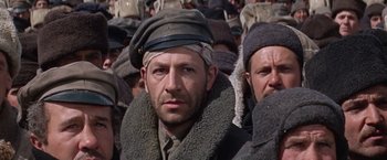 Movie still from “Doctor Zhivago” (1965), directed by David Lean – A group of men standing next to each other wearing hats; Close Up shot, Low angle