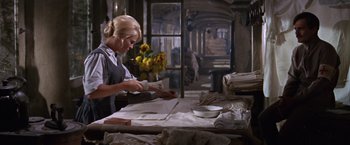 Movie still from “Doctor Zhivago” (1965), directed by David Lean – A woman is cutting paper in a room; Medium shot, Low angle