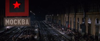 Movie still from “Doctor Zhivago” (1965), directed by David Lean – A train station with people sitting and standing on the tracks; Extreme Wide shot, High angle