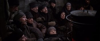 Movie still from “Doctor Zhivago” (1965), directed by David Lean – A group of people sitting on the ground; Wide shot, High angle