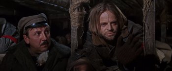 Movie still from “Doctor Zhivago” (1965), directed by David Lean – A person holding a sword in a room; Close Up shot, Low angle