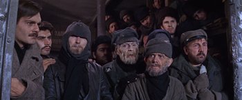 Movie still from “Doctor Zhivago” (1965), directed by David Lean – A group of men standing next to each other; Medium shot, Low angle