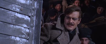Movie still from “Doctor Zhivago” (1965), directed by David Lean – A group of men standing next to each other on a train; Close Up shot, Low angle