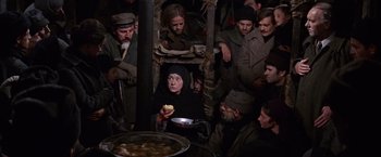 Movie still from “Doctor Zhivago” (1965), directed by David Lean – A group of people sitting around a table; Medium shot, High angle