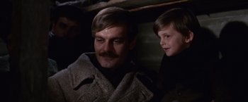 Movie still from “Doctor Zhivago” (1965), directed by David Lean – A man and a boy are standing next to each other; Close Up shot, Low angle