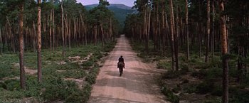 Movie still from “Doctor Zhivago” (1965), directed by David Lean – A man riding a horse down a dirt road; Extreme Wide shot, High angle