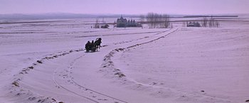 Movie still from “Doctor Zhivago” (1965), directed by David Lean – Two people are riding a horse and carriage through a snowy field; Extreme Wide shot, High angle
