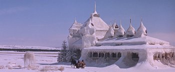 Movie still from “Doctor Zhivago” (1965), directed by David Lean – Two people riding a horse drawn carriage in front of an ice castle; Extreme Wide shot, Low angle