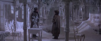 Movie still from “Doctor Zhivago” (1965), directed by David Lean – Two men in fur coats are standing in the snow; Wide shot, High angle